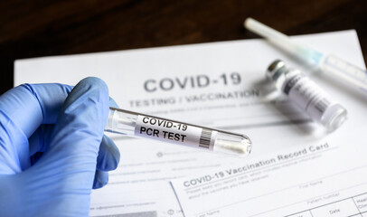 COVID-19 PCR test in doctor`s hand in clinic, coronavirus vaccination concept