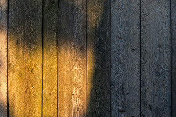 Old wooden planks textured background with sunbeam on it.