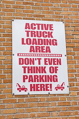 An imaginative sign for a truck loading area tells motorists not to park there in no uncertain terms.