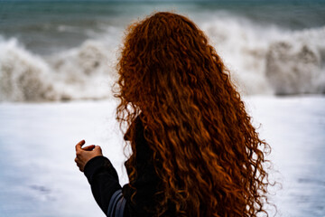 girl with red hair on the background of the storm