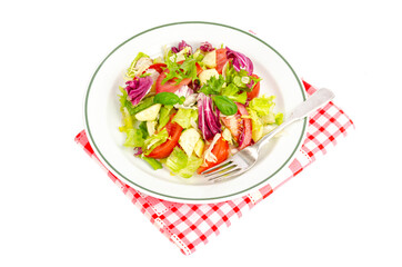 Plate with lettuce, tomatoes, olive oil. Vegetarian menu.