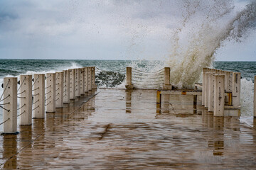 waves roll on the pier during a storm
