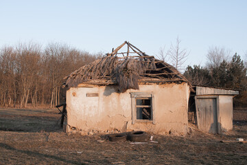 The house is a ruin. The roof is destroyed, windows are broken, the walls are leaning.