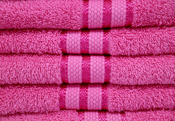 Fototapeta na wymiar Front View of Fuchsia Pink Fluffy Towels Stack 