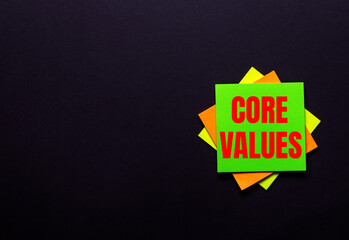 The words CORE VALUES on a bright sticker on a dark background. Copy space