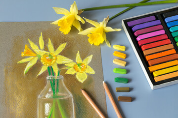 Soft pastel painting at home. Pastel painting of daffodils. Colored pastel set.