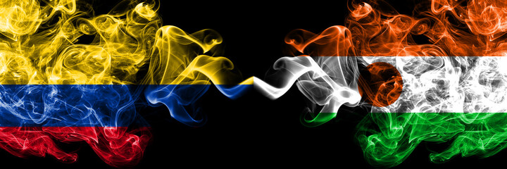 Colombia, Colombian vs Niger, Nigerien smoky mystic flags placed side by side. Thick colored silky abstract smokes flags.