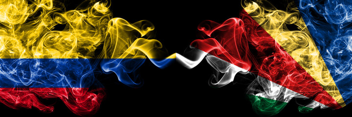 Colombia, Colombian vs Seychelles, Seychellois smoky mystic flags placed side by side. Thick colored silky abstract smokes flags.