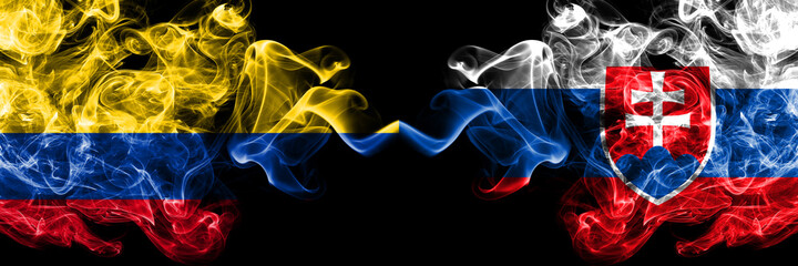 Colombia, Colombian vs Slovakia, Slovakian smoky mystic flags placed side by side. Thick colored silky abstract smokes flags.