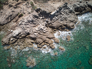 Aerial shot of a huge rock formation surrounded by seawater