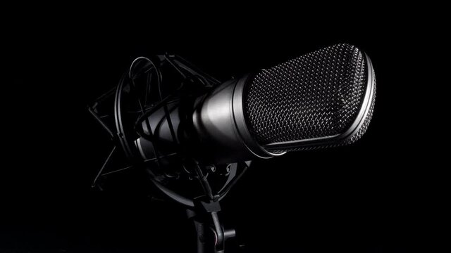 Professional studio microphone on an anti vibration stand, being side lit