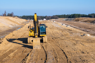 Excavator on a highway construction site. Road construction work