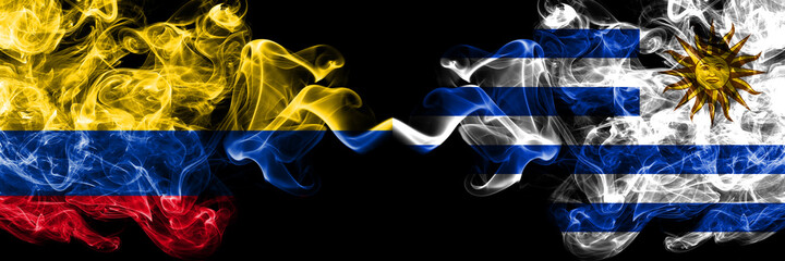 Colombia, Colombian vs Uruguay, Uruguayan smoky mystic flags placed side by side. Thick colored silky abstract smokes flags.