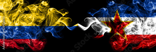 Colombia, Colombian vs Yugoslavia, Yugoslavian smoky mystic flags placed side by side. Thick colored silky abstract smokes flags.