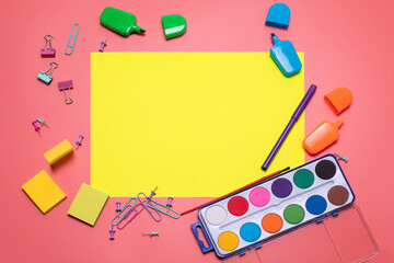 Stationery items on the pink background with free space for text. Creative, colorful background with scool supplies. Flatlay with copy space, top view. Markers, paper clips, sticky notes