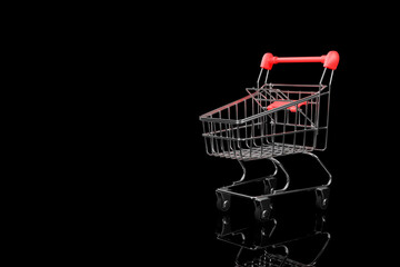 Supermarket trolley close-up on a black background.3D rendering.