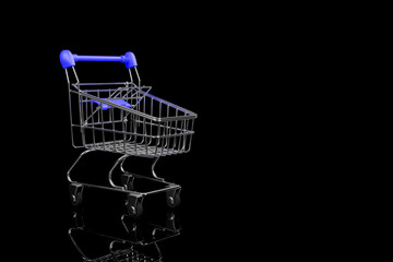 Close up of a shopping cart on a black background.3D rendering.