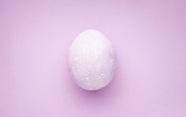 Easter egg on a purple background. Flat lay.