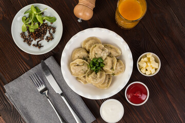 Dumplings with ketchup and sour cream. Flat lay