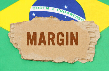 Against the background of the flag of Brazil lies cardboard with the inscription - margin