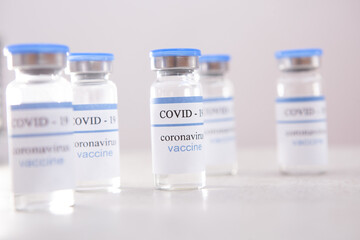 Vaccination covid-19 ampoules on light background, coronavirus vaccine