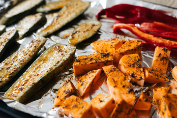 Raw chopped vegetables as sweet potatoes, zucchini, cappi pepper in a dish roast.
Vegan and health food concept