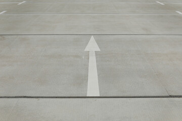 White arrow on the street for a street sign, space for text, background for template and no person