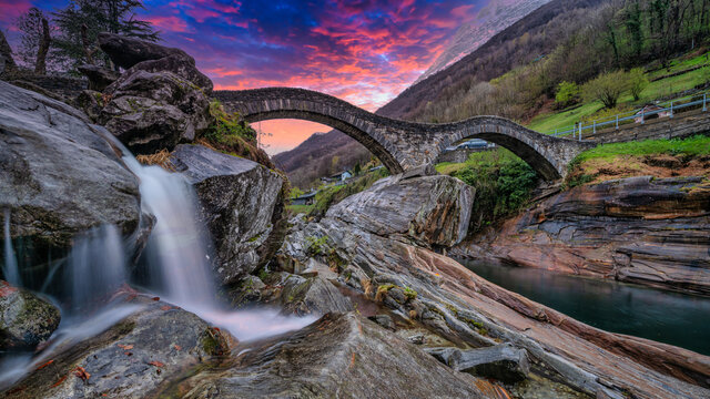 A double arch stone bridge at Ponte dei Salti over the clear water of the Verzasca River. Travel Switzerland near  Lavertezzo, Ticino.