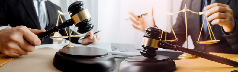 Business and lawyers discussing contract papers with brass scale on desk in office. Law, legal services, advice, justice and law concept picture with film grain effect