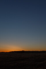Fototapeta na wymiar The sky after sunset over the field.