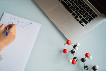 Woman studying chemistry with a molecular model of fructose