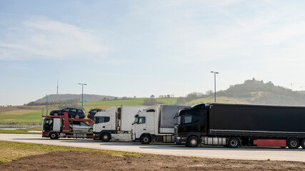 Group of supplies Tir camion on motorway parking,shipment goods transportation
