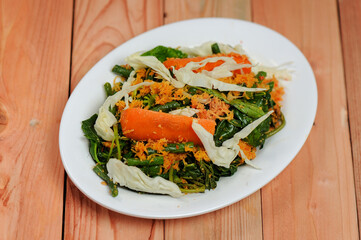 Urap (Indonesia Traditional Food). Urap is a salad dish of steamed vegetables mixed with seasoned and spiced grated coconut for dressing