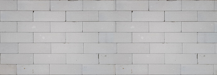 Naklejka premium A fragment of a white wall made of blocks, rough masonry, texture or wallpaper