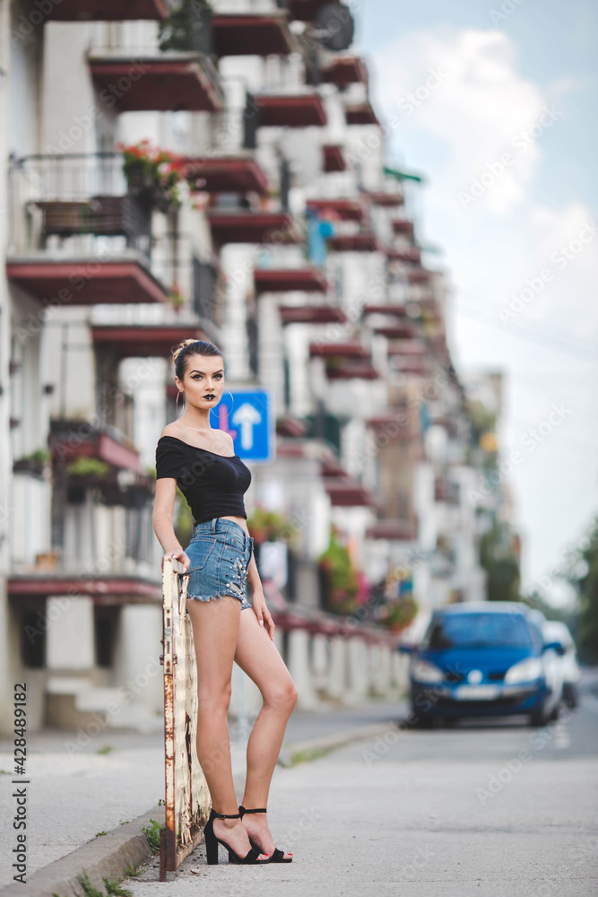 Wall mural Shallow focus shot of a confident Caucasian female posing for the camera outdoor