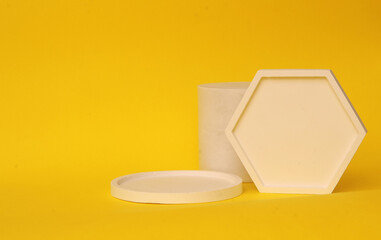 Podium in yellow color with geometric shapes. Stage with concrete, plaster geometric geometric shapes.