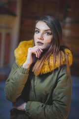 Shallow focus shot of a confident Caucasian female in a puffer posing for the camera