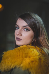 Shallow focus shot of a confident Caucasian female in a puffer posing for the camera