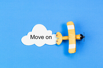writing Move on red toy airplane with cloud on blue background