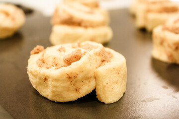 Delicious uncooked cinnamon roll on a pan waiting to be cooked