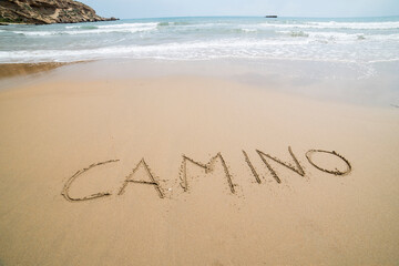 Words written on the sand on the beach, the sign says ... way, 
the boy that