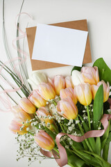 postcard layout. bouquet of tulips on white background and space for text 