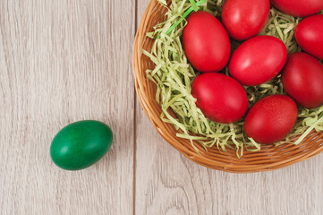 Traditional red and green Easter eggs on white wood background. Top view point.