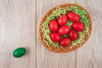 Traditional red and green Easter eggs on white wood background. Top view point.
