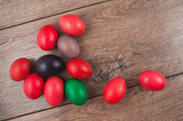 Colorful Easter eggs on color wooden background