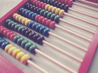 Education concept - abacus with many colorful beads. Red, blue, green, black, yellow details on the...