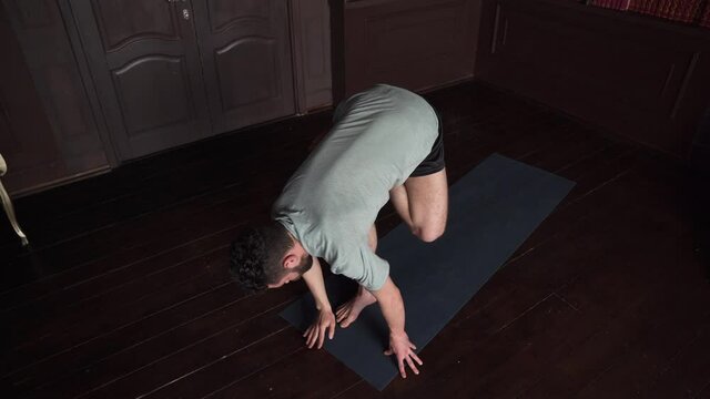 Young Man Practicing Yoga Fitness Exercises Indoors.