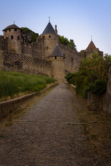 Fototapeta na wymiar Landscape at sunrise of the access ramp to the castle and the fortified city of Carcassonne, UNESCO World Heritage Site, France