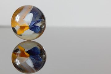 Little blue and yellow marble - stock photo