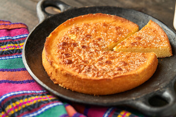 Latin sweet cheese bread dessert in a clay plate, salvadoran quesadilla